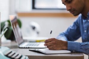 Man studying French on a notebook